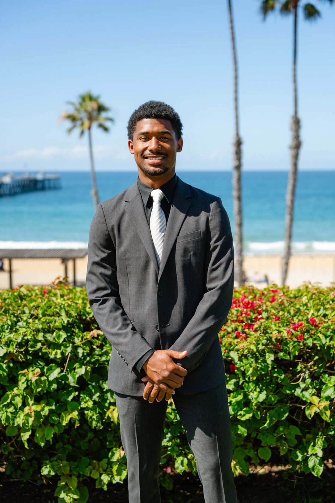 Roy Quick in a charcoal suit at the San Clemente Pier